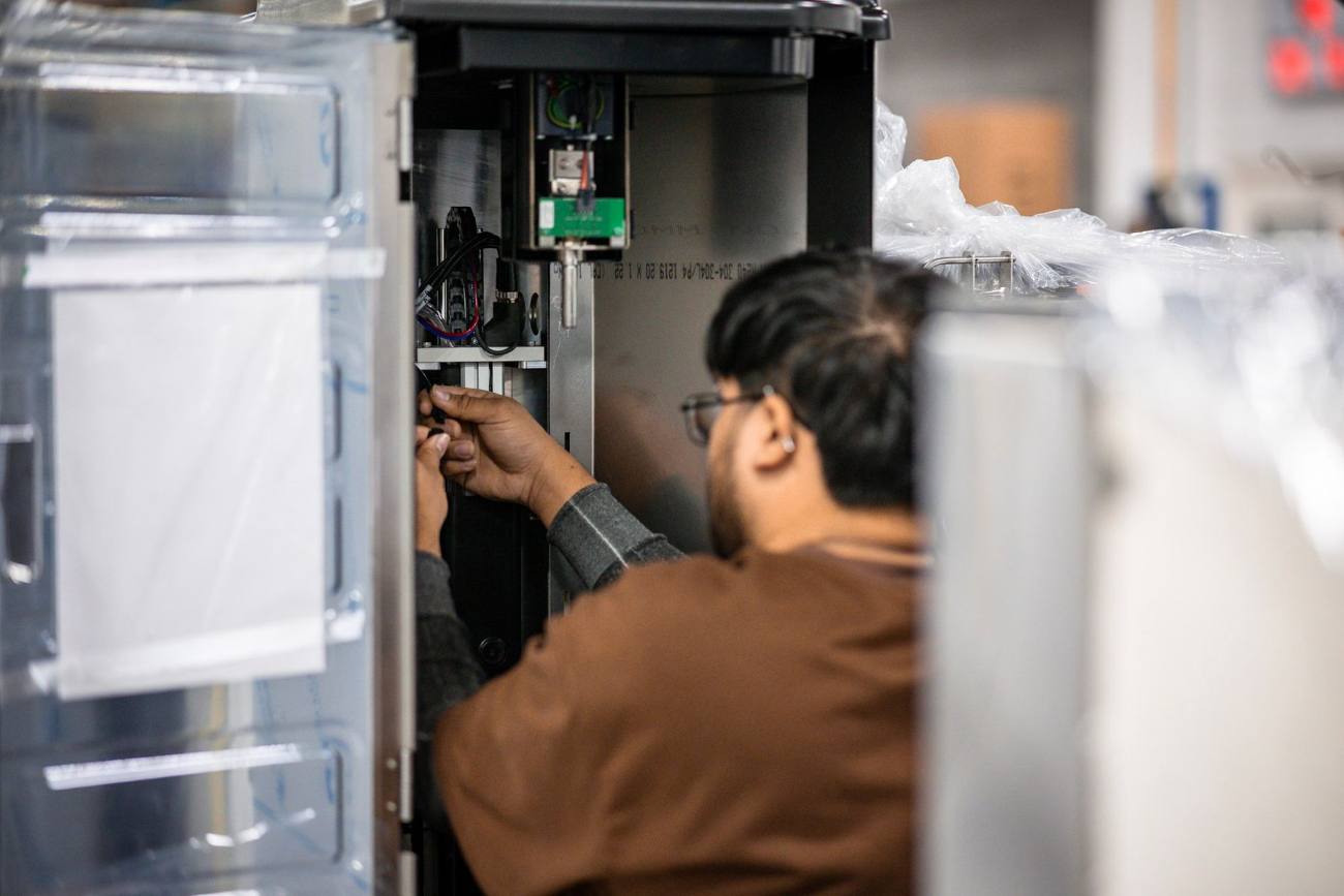 Marmon Renew technician disassembling beverage equipment for full remanufacturing on the shop floor